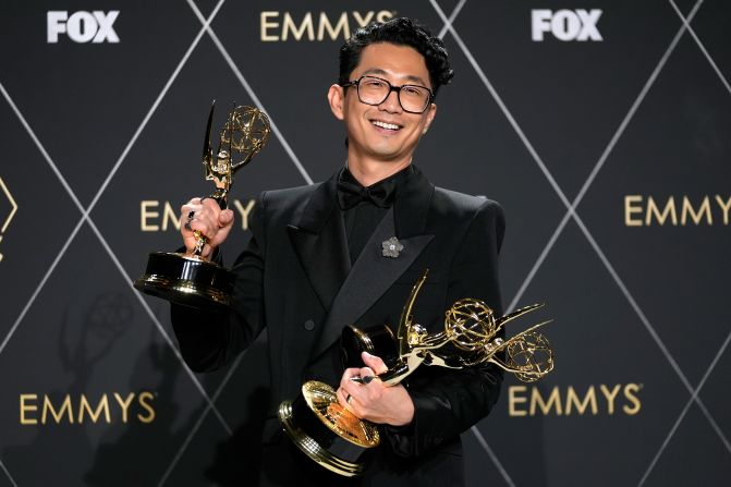 Lee Sung Jin, the creator of the limited series "Beef," poses with some of the Emmys the show won on Monday.