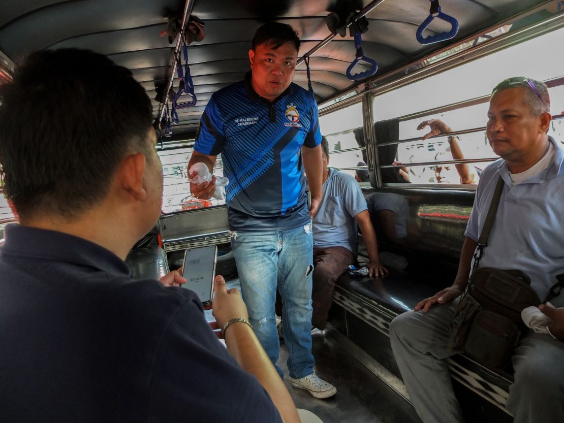 CALOOCAN CITY, METROL MANILA, PHILIPPINES - 2023/12/18: Manibela President, Mar Valbuena is interviewed by a news reporter inside their proposed version of modernized jeepney during the demontration. Public transport organisation MANIBELA (Samahang Manibela Mananakay at Nagkaisang Terminal ng Transportasyon), led by President Mar Valbuena, held a protest at Monumento Circle in Caloocan City, urging President Bongbong Marcos Jr. to reconsider the deadline for consolidating jeepney operators' franchises. While the Land Transportation Franchising and Regulatory Board (LTFRB) memo shields consolidated operators from franchise revocation until December 31, 2024, those missing the December 31, 2023 deadline face revocation from January 1, 2024. Protesters argue that this endangers the livelihoods of public utility jeepneys and UV Express drivers, many of whom cannot afford the consolidation. Some who have already consolidated are in debt and still struggling to make a living. According to the Department of Transportation's data, approximately 71,395 units (64,639 PUJs & 6,756 UVEs) nationwide remain unconsolidated. (Photo by Josefiel Rivera/SOPA Images/LightRocket via Getty Images)