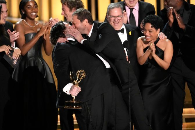 Matty Matheson, left, is kissed by co-star Ebon Moss-Bachrach after "The Bear" won the Emmy Award for outstanding comedy series on Monday, January 15.