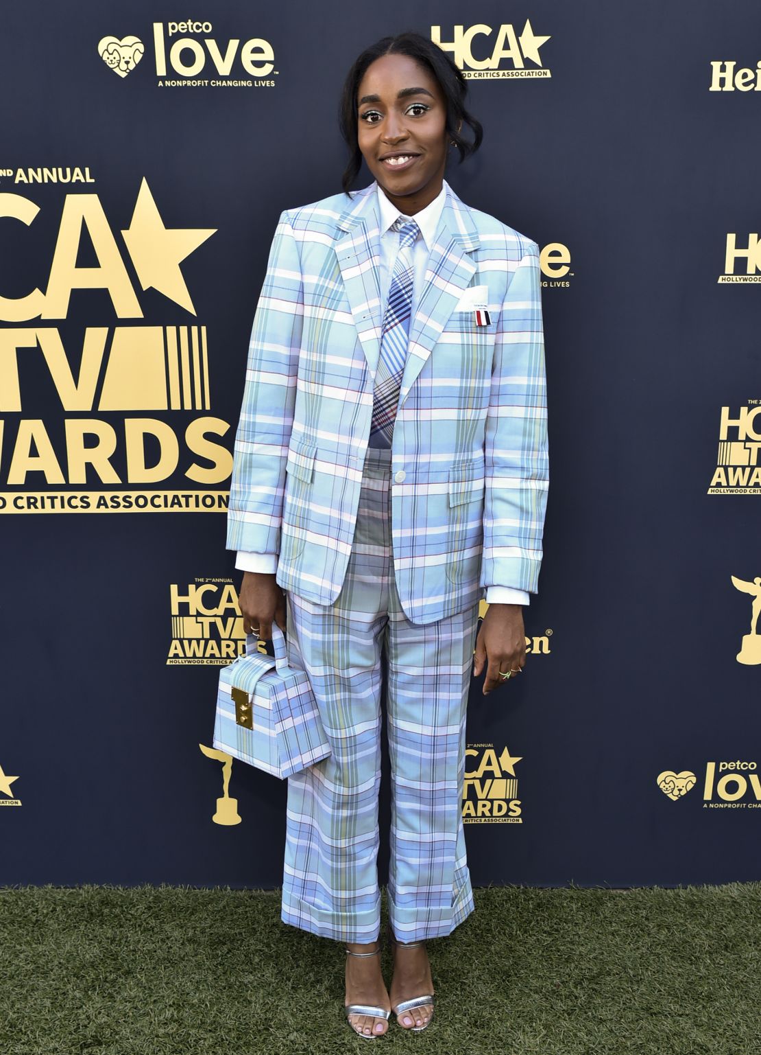 At the HCA TV Awards on August 14, 2022, Edebiri favored suiting again, this time in a relaxed pale blue check two piece with clashing tie by Thom Browne.