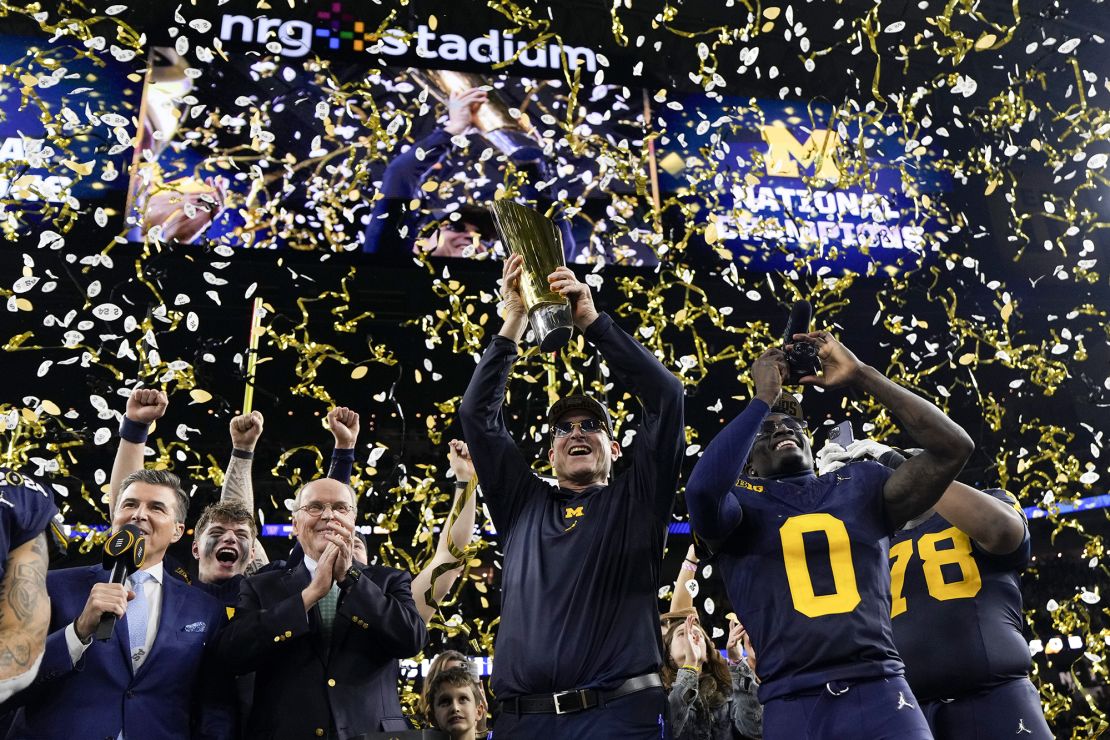 Michigan head coach Jim Harbaugh celebrates with the trophy after their win against Washington in the national championship NCAA College Football Playoff game Monday, Jan. 8, 2024, in Houston. (AP Photo/David J. Phillip)