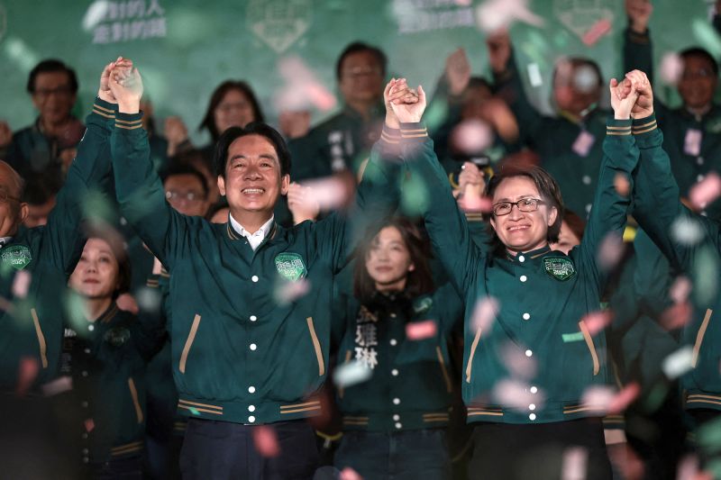 Taiwan's President-Elect, Lai Ching-te (left), celebrates with his running mate, Hsiao Bi-khim, during a rally outside the headquarters of the Democratic Progressive Party (DPP) in Taipei on January 13, after winning the presidential election.
