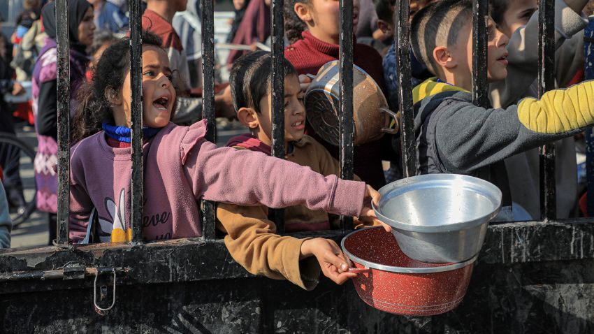 Children try to get food relief in the southern Gaza Strip city of Rafah, on December 31, 2023. 