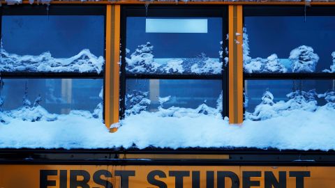 A snow covered school bus sits in a parking lot in Wheeling, Ill., Tuesday, Jan. 16, 2024. Illinois school cancels classes Tuesday due to extreme cold. (AP Photo/Nam Y. Huh)