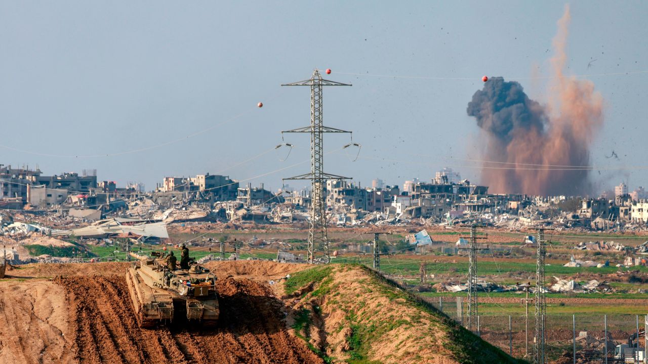 This picture taken from a position in southern Israel, on the border with Gaza shows smoke billowing over the Palestinian territory during Israeli bombardment as an Israeli tank takes position on January 16, 2024, amid ongoing battles between Israel and the militant Hamas group.