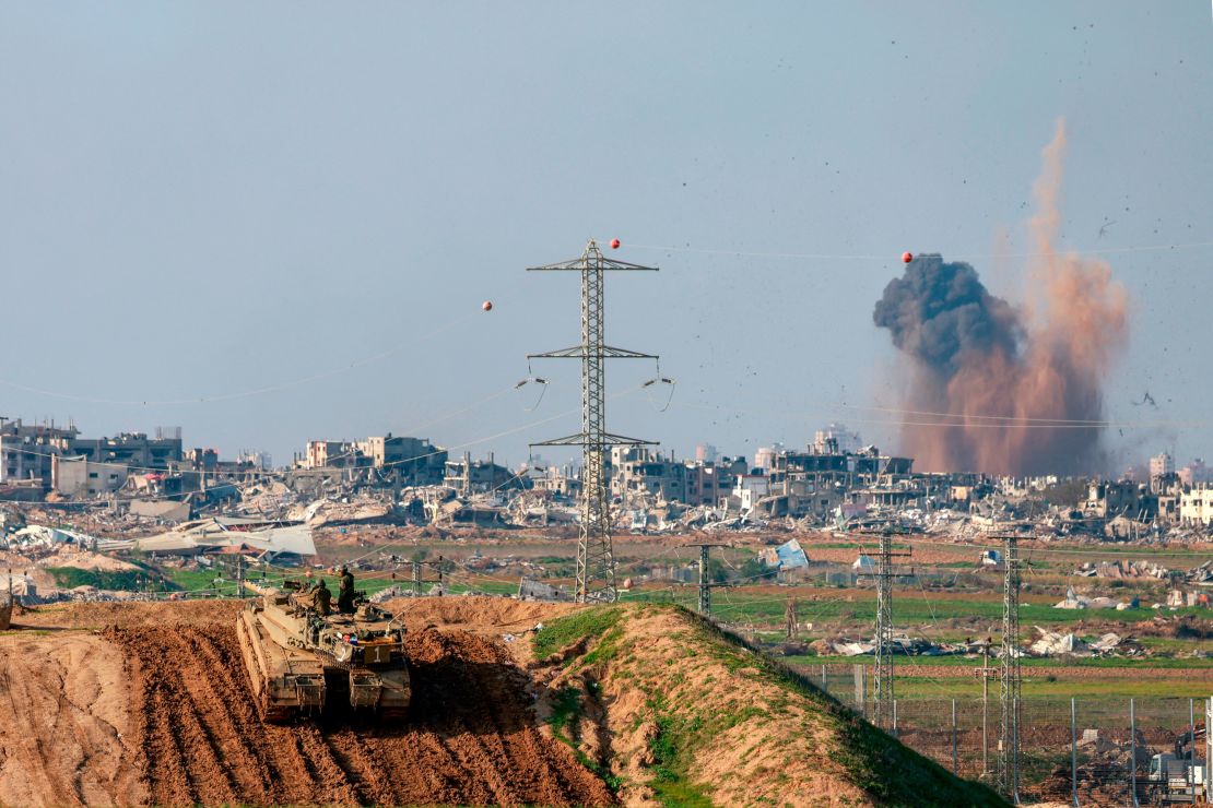 This picture taken from a position in southern Israel, on the border with Gaza shows smoke billowing over the Palestinian territory during Israeli bombardment as an Israeli tank takes position on January 16, 2024, amid ongoing battles between Israel and the militant Hamas group.