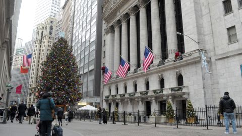 Daily Life in Wall Street and the Financial District, New York City, USA - 04 Jan 2024
Pedestrians take photos and walk past the New York Stock Exchange where there is a nearby Christmas tree ornamented in holiday decorations.