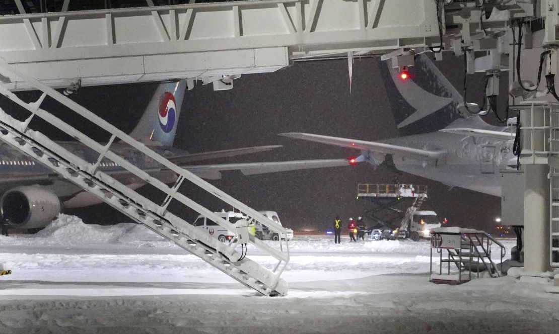 A Korean Air plane, left, and Cathay Pacific aircraft, right, are seen after a collision at northern Japan's New Chitose Airport in Sapporo, Tuesday, Jan. 16, 2024. A Korean Air plane carrying 289 people hit a parked Cathay Pacific aircraft while being pushed by a ground vehicle ahead of takeoff at northern Japan's New Chitose Airport on Tuesday but caused no fire or injuries, fire and airline officials said. (Kyodo News via AP)