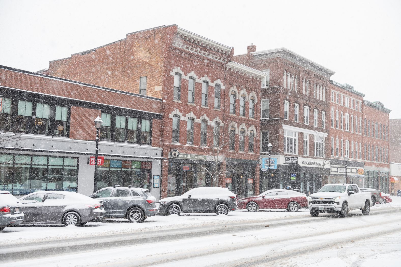 Snow falls on parked cars in Concord, New Hampshire, on January 16.