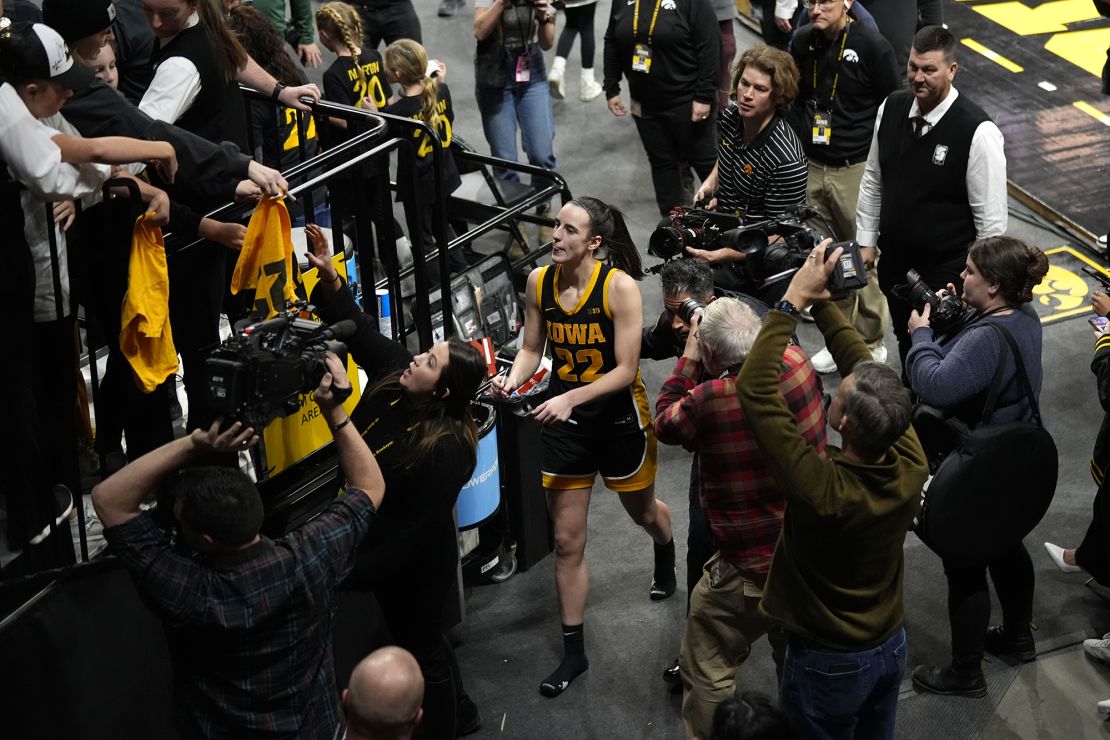 Iowa guard Caitlin Clark (22) signs autographs as she walks off the court after an NCAA college basketball game against Wisconsin, Tuesday, Jan. 16, 2024, in Iowa City, Iowa. Iowa won 96-50. (AP Photo/Charlie Neibergall)