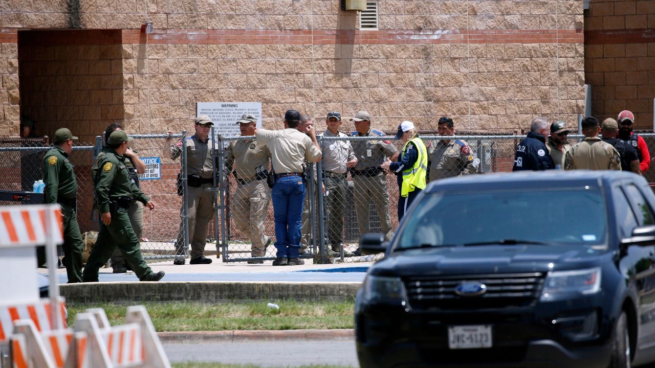 FILE - Law enforcement, and other first responders, gather outside Robb Elementary School following a shooting, May 24, 2022, in Uvalde, Texas. Four months after the Robb Elementary School shooting, the Uvalde school district on Friday, Oct. 7 pulled its entire embattled campus police force off the job following a wave of new outrage over the hiring of a former Texas state trooper who was part of the hesitant law enforcement response as a gunman killed 19 children and two teachers. (AP Photo/Dario Lopez-Mills, File)