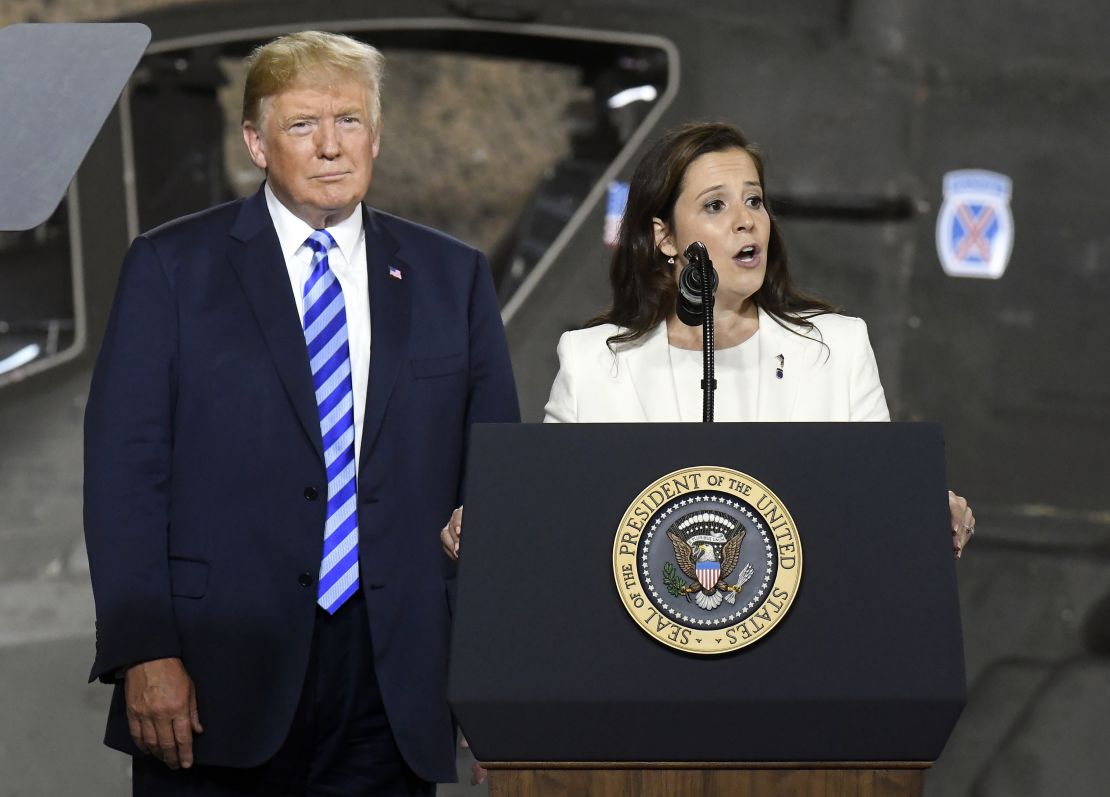 In this Aug. 13, 2018 file photo, President Donald Trump, left, listens as Rep. Elise Stefanik, R-N.Y., speaks before signing a $716 billion defense policy bill named for John McCain at Fort Drum, N.Y. (AP Photo/Hans Pennink, File)