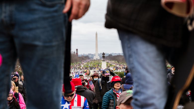 WASHINGTON, DC - JANUARY 06: The Washington Monument is seen in the background as pro-Trump protesters break through barriers onto the grounds of the Capitol Building on January 6, 2021 in Washington, DC. A pro-Trump mob stormed the Capitol earlier, breaking windows and clashing with police officers. Trump supporters gathered in the nation's capital to protest the ratification of President-elect Joe Biden's Electoral College victory over President Donald Trump in the 2020 election. (Photo by Jon Cherry/Getty Images)