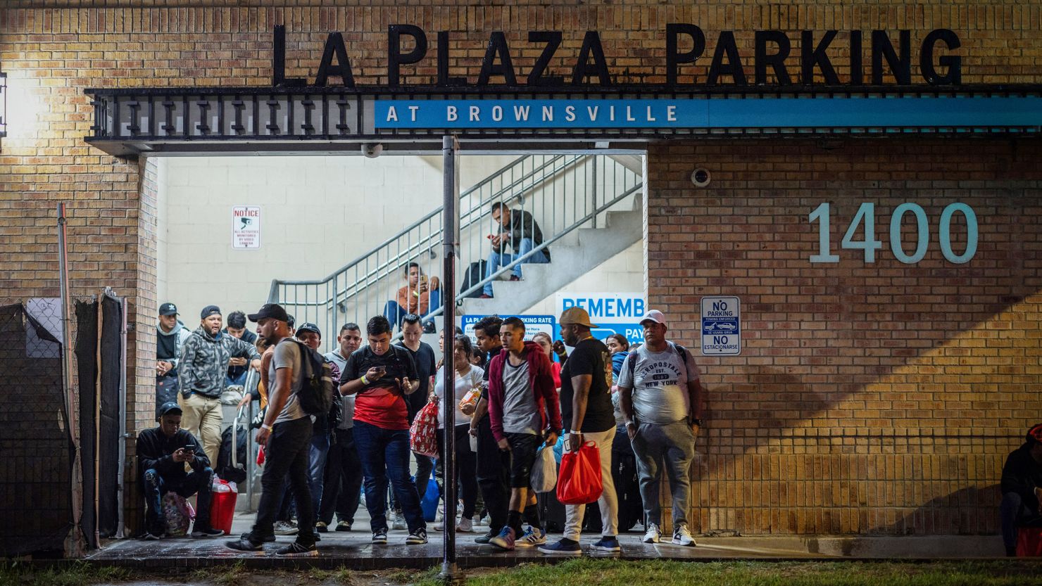 Migrants stand at a processing center as they wait for a bus to Chicago, in downtown Brownsville, Texas, in October last year.