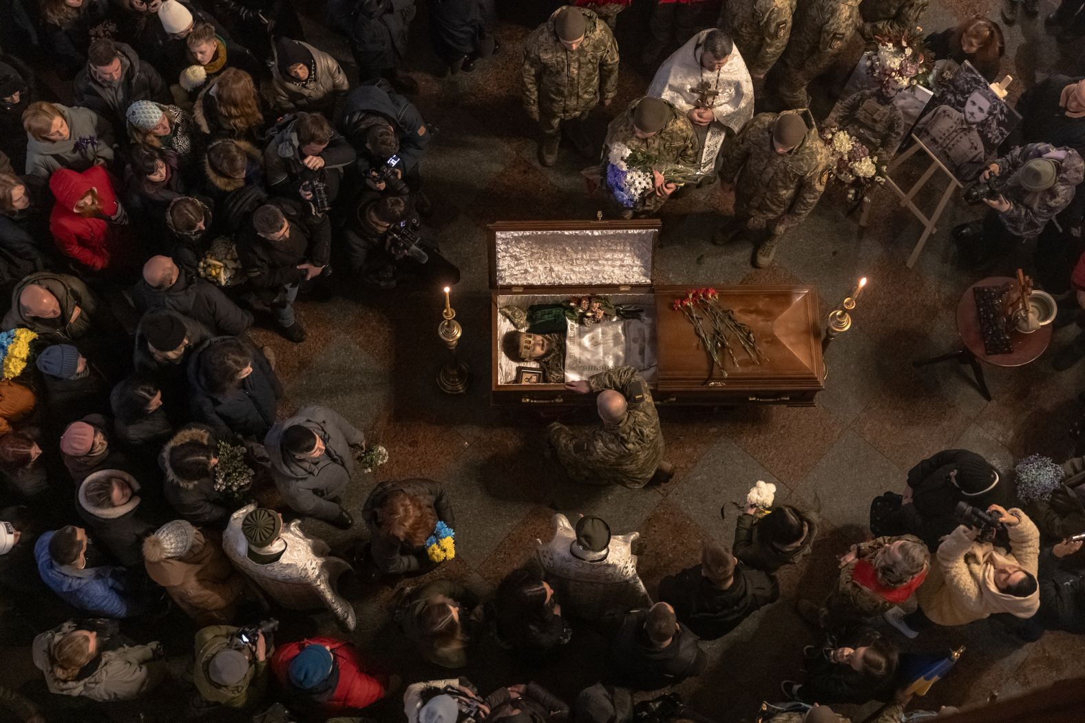 People mourn next to the coffin of Ukrainian poet and serviceman Maksym Kryvtsov at St. Michael's Golden-Domed Monastery in Kyiv, Ukraine, on Thursday, January 11.