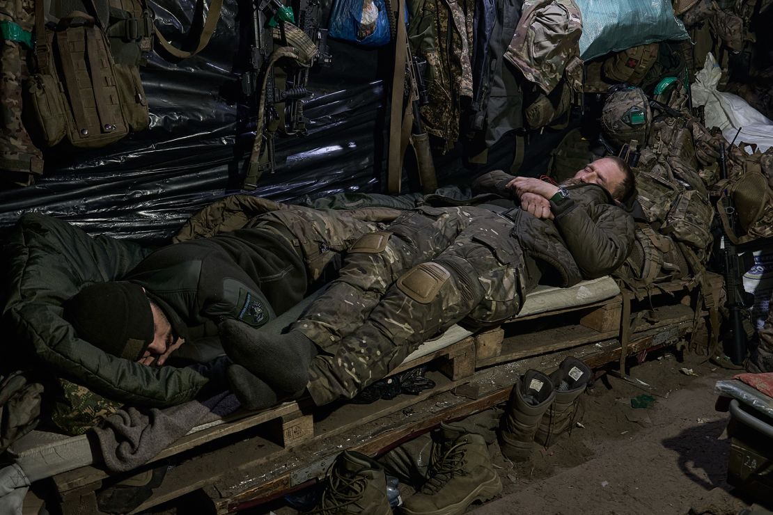 KREMINNA, UKRAINE - JANUARY 12: Soldiers sleep in the dugout after their shift as the soldiers of Ukrainian National Guard hold their positions in the snow-covered Serebryan Forest in temperatures of -15°C on January 12, 2024 in Kreminna, Donetsk Oblast, Ukraine. (Photo by Kostiantyn Liberov/Libkos/Getty Images)