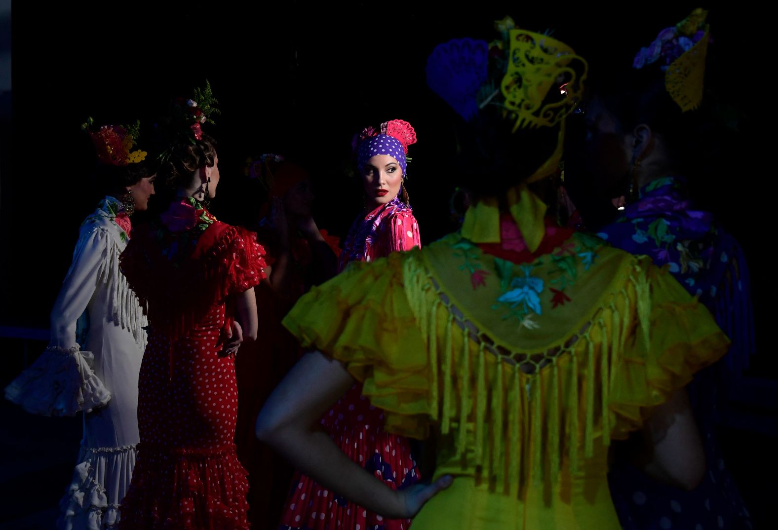 Models wait at backstage before presenting creations by Pilar Vera during the International Flamenco Fashion Week in Seville, Spain, on Thursday, January 18.