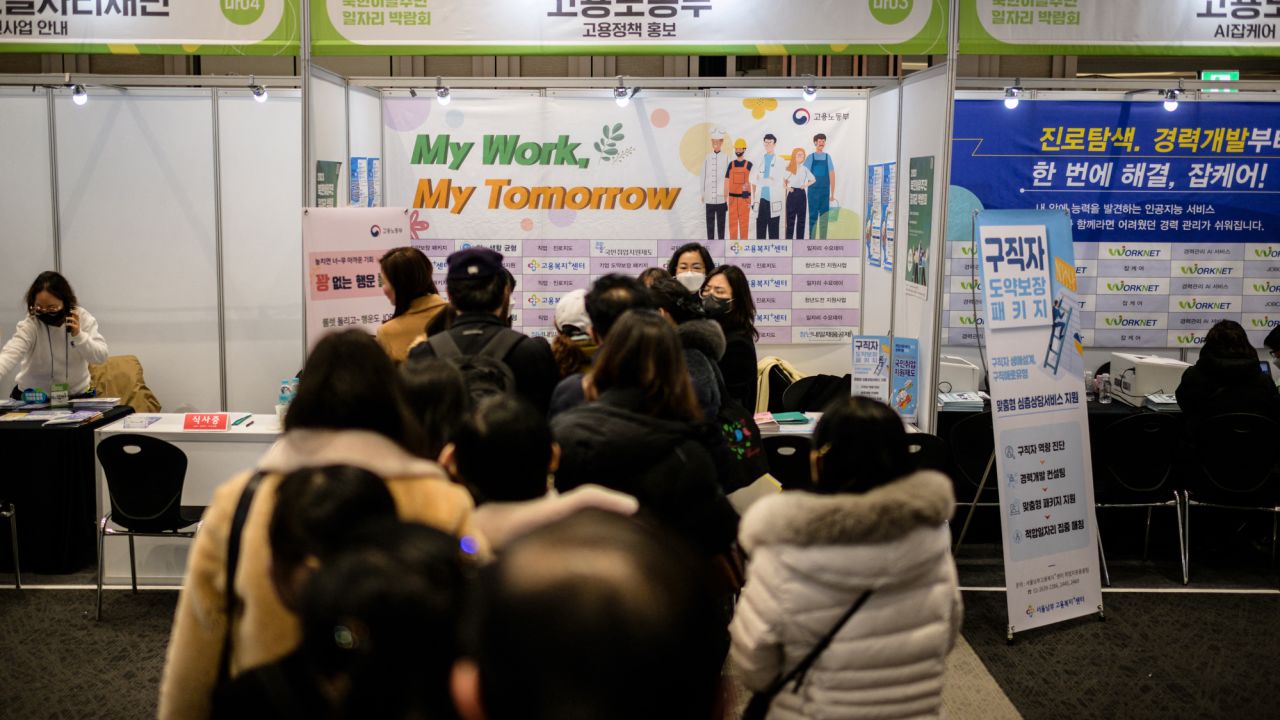 This photo taken on December 1, 2023 shows people lining up at a job fair for North Korean defectors in Seoul. Some defectors have struggled to integrate. Decades of division coupled with South Korea's rapid economic development, mean there are linguistic, cultural and practical challenges to overcome. The job fair is one of many initiatives organised by the government that seeks to improve this. (Photo by Anthony WALLACE / AFP) / TO GO WITH NKorea-SKorea-defection-rights, FOCUS by Sunghee Hwang (Photo by ANTHONY WALLACE/AFP via Getty Images)