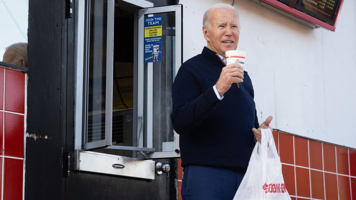 US President Joe Biden holds a milkshake during a quick stop at Cook Out, a restaurant in Raleigh, North Carolina, following an event to promote his economic agenda on January 18, 2024.