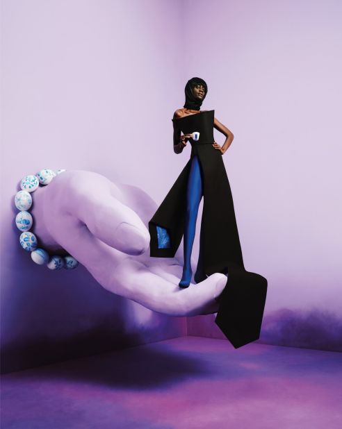 According to Verrips, the giant tie worn by the model in "The Vanguard" symbolizes masculinity, while the leggings symbolize femininity. Together, the image represents the fight for gender equality.