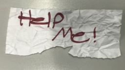 In this undated photo released by the U.S Department of Justice is a "Help Me!" sign used by a 13-year-old girl kidnapped in Texas. The girl was rescued in Southern California on July 9, 2023, when passersby saw her hold up the sign in a parked car, police said. The rescue occurred in Long Beach when officers responded to a trouble call and found the "visibly emotional and distressed girl," police said in a press release Thursday, July 20.  (U.S. Department of Justice via AP)