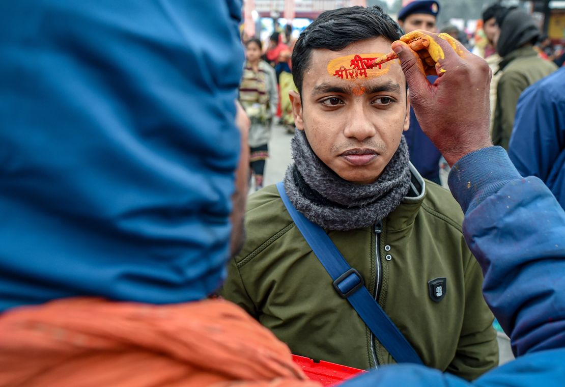 A devotee gets anoint the name of Lord Ram on his forehead ahead of the Inauguration of the Ram Mandir Temple on January 20, 2024 in Ayodhya, India.