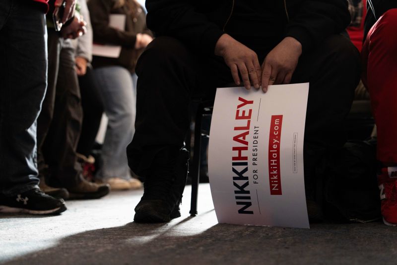 An attendee holds a sign during a campaign event with Nikki Haley, former governor of South Carolina and 2024 Republican presidential candidate, not pictured, at the Artisan Hotel in Salem, New Hampshire, US, on Monday, Jan. 22, 2024. Haley's New Hampshire ambitions depend on high turnout among undeclared voters and former Democrats, strengthening her argument that she can grow the Republican party and win the presidency in November, according to a political strategist supporting her campaign. Photographer: Mel Musto/Bloomberg via Getty Images