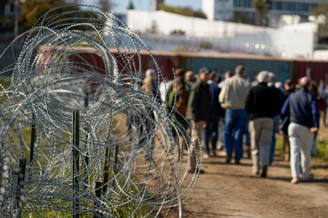 FILE - Concertina wire lines the path as members of Congress tour an area near the Texas-Mexico border, Jan. 3, 2024, in Eagle Pass, Texas. As congressional negotiators try to finalize a bipartisan deal on the border and immigration, their effort is drawing the wrath of hard-right lawmakers and former President Donald Trump. That vocal opposition threatens to unravel a delicate compromise. (AP Photo/Eric Gay, File)