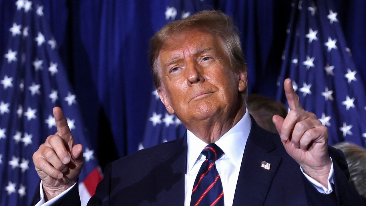 Republican presidential candidate and former U.S. President Donald Trump gestures as he takes the stage during his New Hampshire presidential primary election night watch party, in Nashua, New Hampshire, U.S., January 23, 2024. REUTERS/Mike Segar