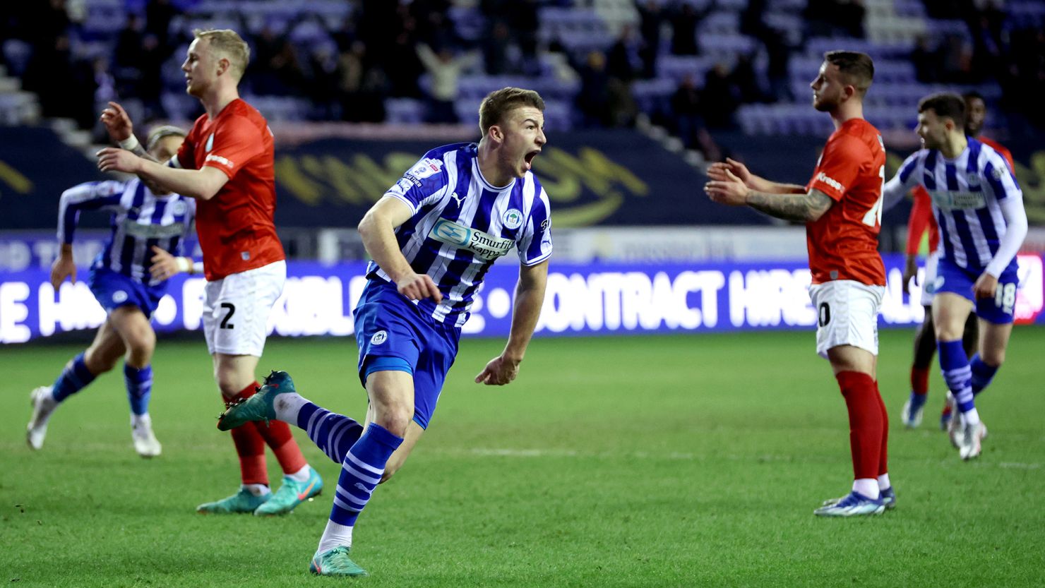 WIGAN, ENGLAND - JANUARY 23: Charlie Hughes of Wigan Athletic celebrates scoring his team's first goal during the Sky Bet League One match between Wigan Athletic and Wycombe Wanderers at DW Stadium on January 23, 2024 in Wigan, England. (Photo by Clive Brunskill/Getty Images)