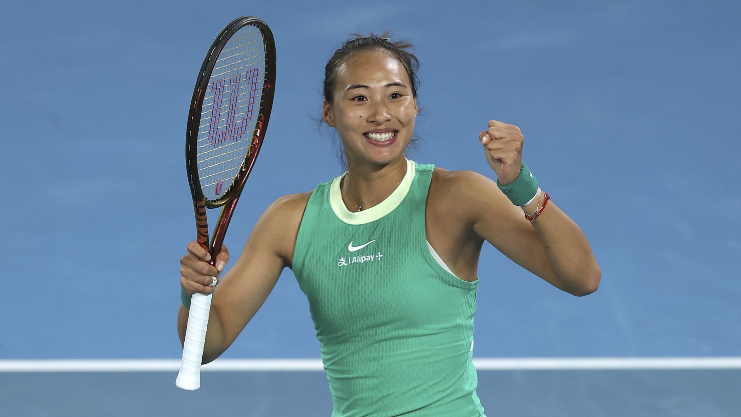 MELBOURNE, AUSTRALIA - JANUARY 24: Qinwen Zheng of China celebrates winning match point during their quarterfinals singles match against Anna Kalinskaya during the 2024 Australian Open at Melbourne Park on January 24, 2024 in Melbourne, Australia. (Photo by Julian Finney/Getty Images)