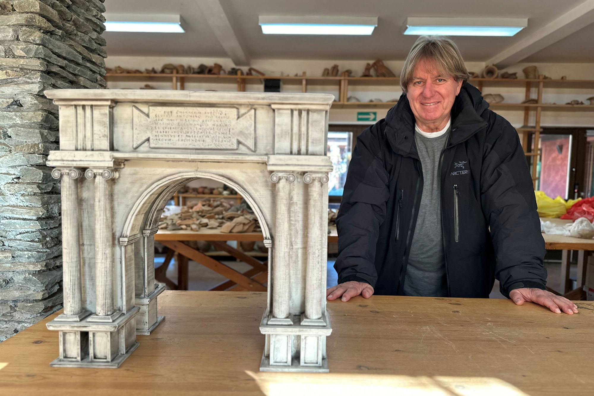 Miomir Korac, the leading archaeologist, poses next to a maquette of an ancient Roman triumphal arch, the remains of which were discovered at the site of Viminacium, a former Roman settlement near the town of Kostolac, Serbia, January 22, 2024.