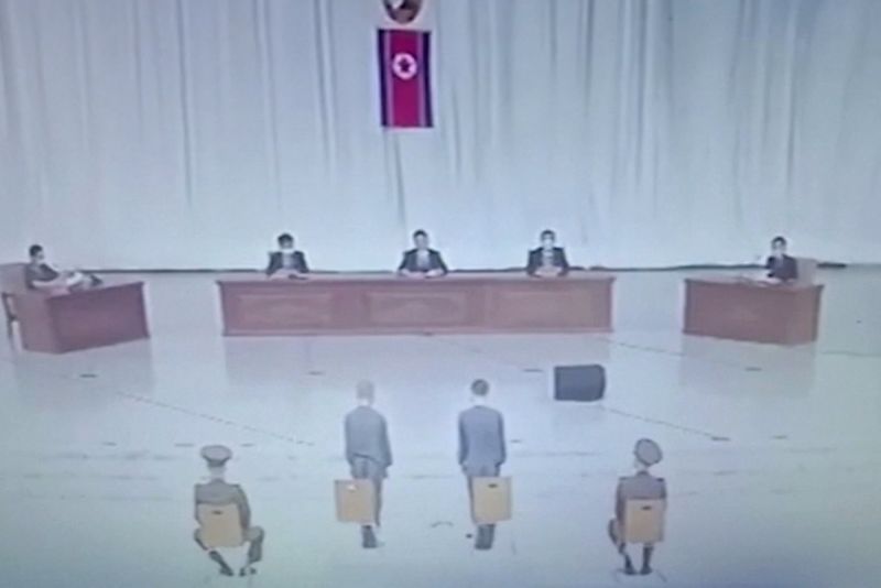 The video shows the teenagers facing a panel on a stage in an ampitheater.