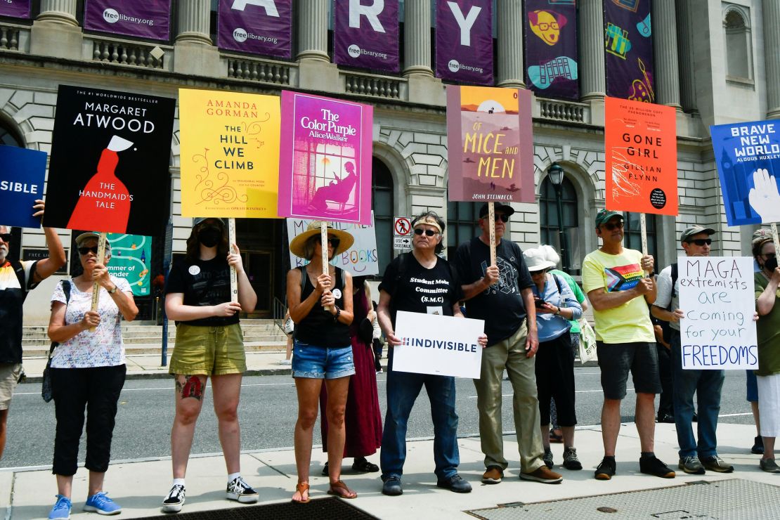 Demonstrators stand outside the Free Library of Philadelphia as the Moms for Liberty group holds a summit at a hotel in the city in June 2023.