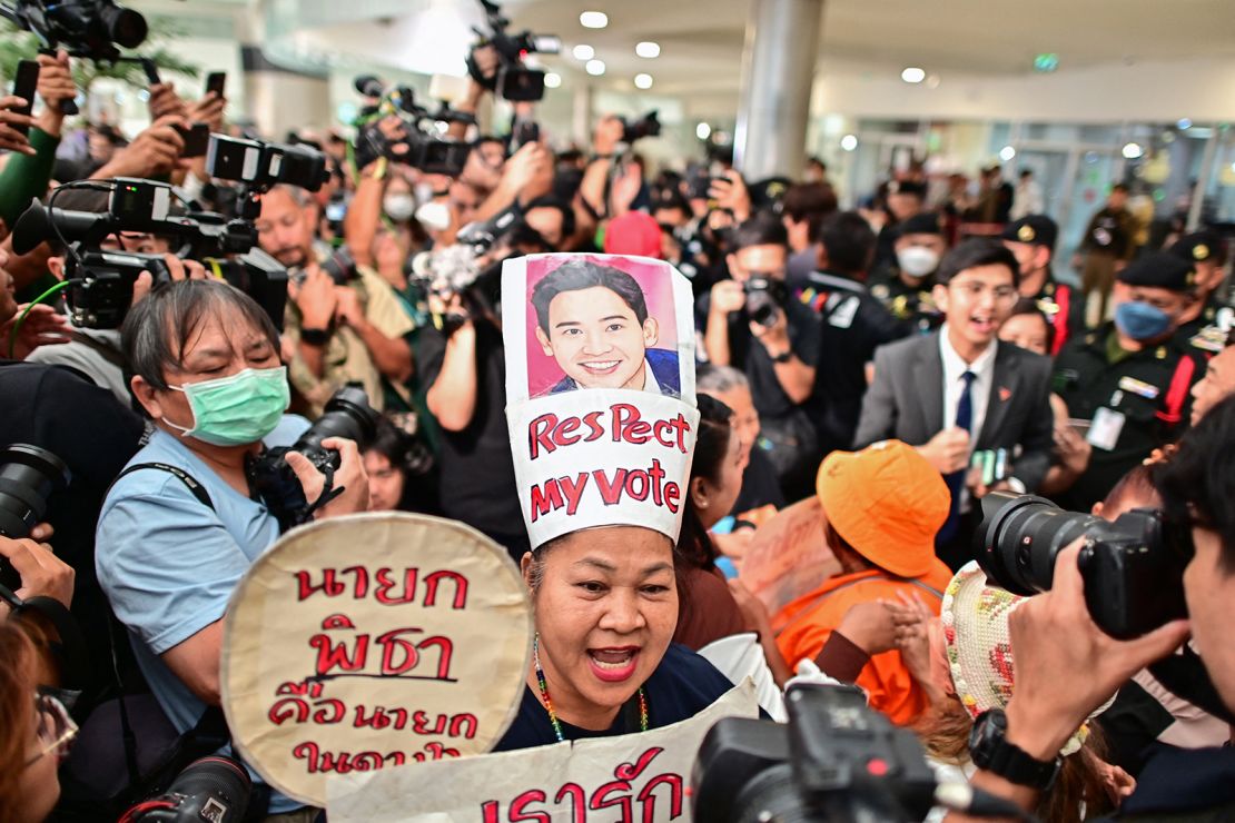 A supporter of former Thai prime ministerial candidate and ex-Move Forward Party leader Pita Limjaroenrat celebrates outside the Constitutional Court in Bangkok on January 24, 2024, after the court decided to reinstate him as a lawmaker.