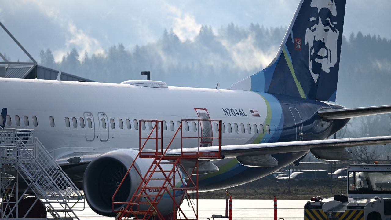 Alaska Airlines N704AL, a 737 Max 9, which made an emergency landing at Portland International Airport on January 5 is parked at a maintenance hanger in Portland, Oregon on January 23, 2024. The missing emergency door is covered and taped. One of two door plugs on the emergency exit door blew out shortly after the plane took off from Portland. No fatalities or injuries were reported. The US Federal Aviation Administration (FAA) announced January 11 it was launching a safety probe into Boeing's quality control.