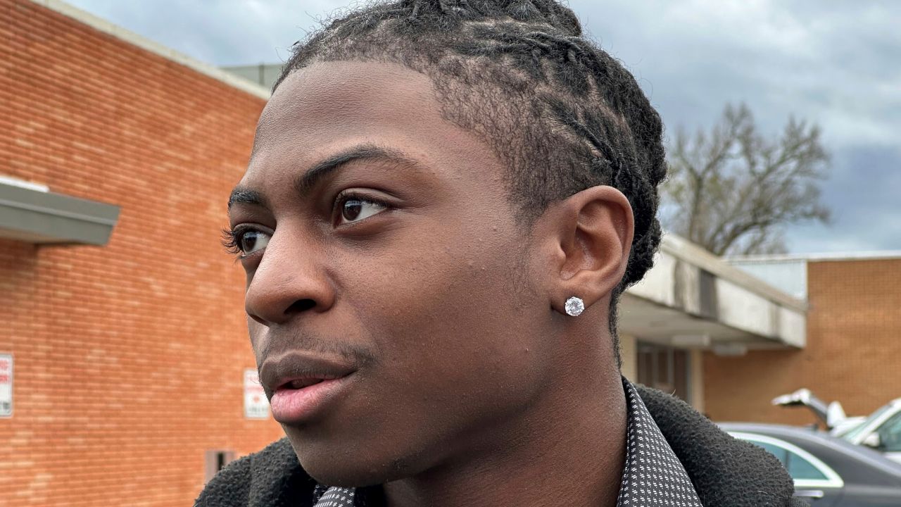 Darryl George, an 18-year-old high school junior, stands outside a courthouse in Anahuac, Texas, on Wednesday, Jan. 24, 2024. A judge ordered Wednesday that a trial be held next month to determine whether George can continue being punished by his district for refusing to change a hairstyle he and his family say is protected by a new state law.