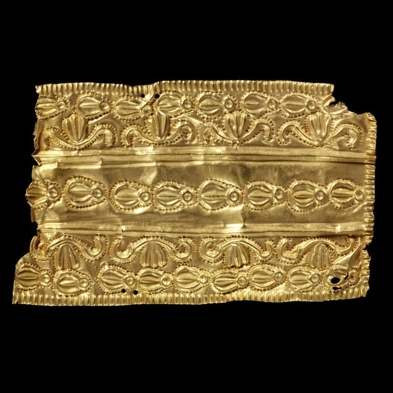 A gold ornament with three bands of decoration.