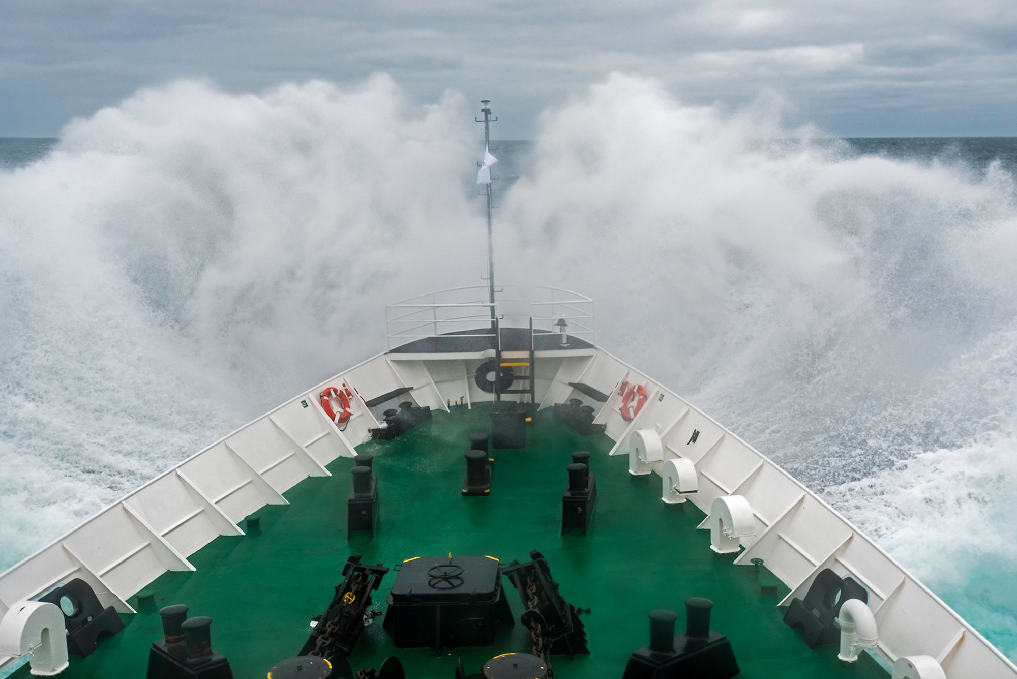 Wave breaking over the bow of a ship in the Scotia Sea of the Southern Ocean."n