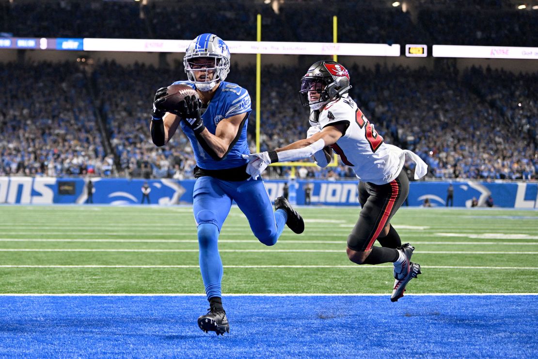 Jan 21, 2024; Detroit, Michigan, USA; Detroit Lions wide receiver Amon-Ra St. Brown (14) makes a catch for a touchdown against Tampa Bay Buccaneers cornerback Zyon McCollum (27) during the second half in a 2024 NFC divisional round game at Ford Field. Mandatory Credit: Lon Horwedel-USA TODAY Sports