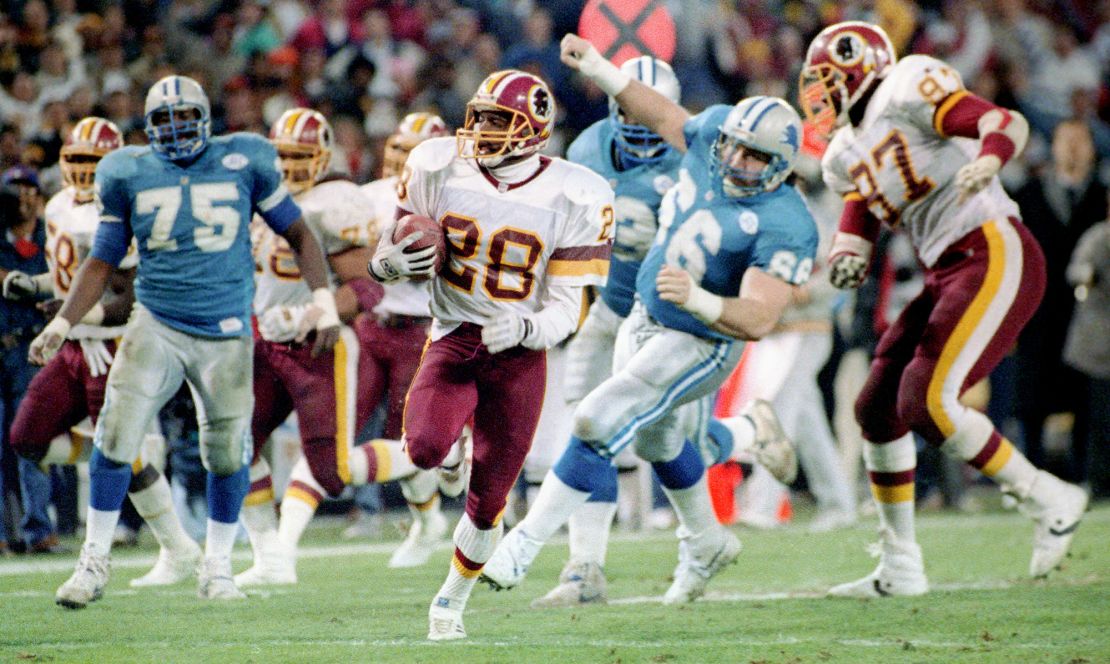 WASHINGTON DC , JANUARY 12:  Redskins corner back Darrell Green , center, runs an interception back for  touchdown during The Washington Redskins defeat  of the Detroit Lions 41 - 10 in the NFC finals at RFK Stadium in Washington DC, January 12,1992.  (Photo by Rich Lipski/The Washington Post via Getty Images)