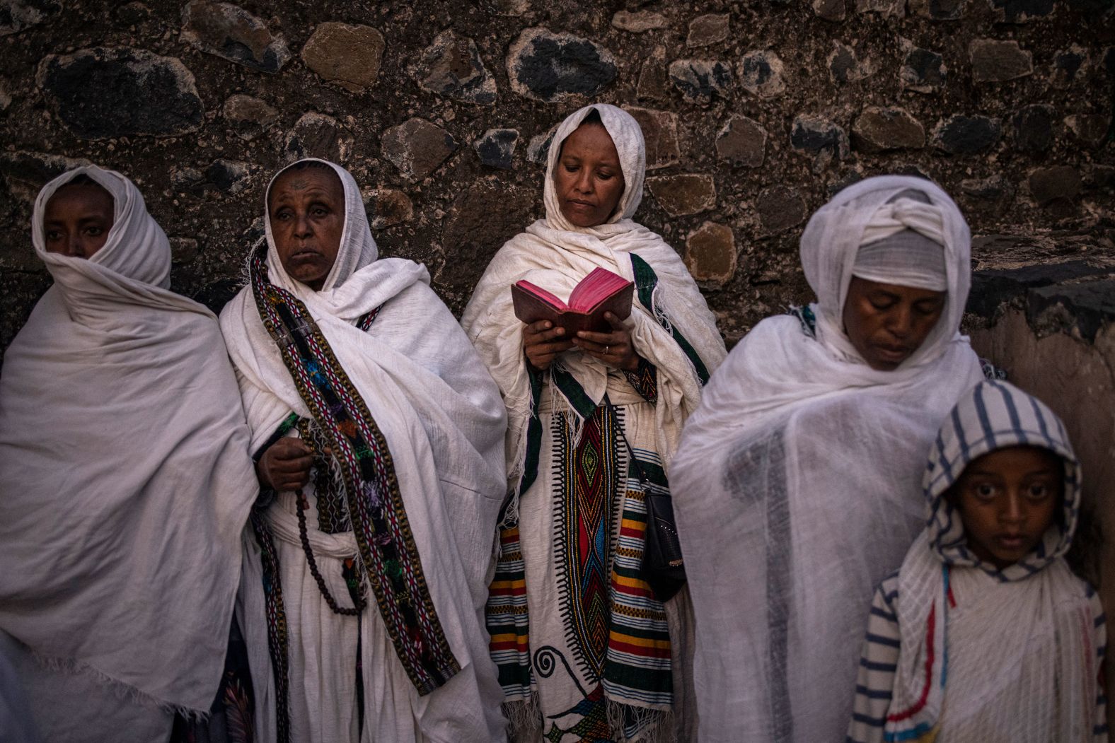 An Ethiopian Orthodox worshipper reads prayers from the Bible during the holy festival of Timket in the city of Gondar on Saturday, January 20.