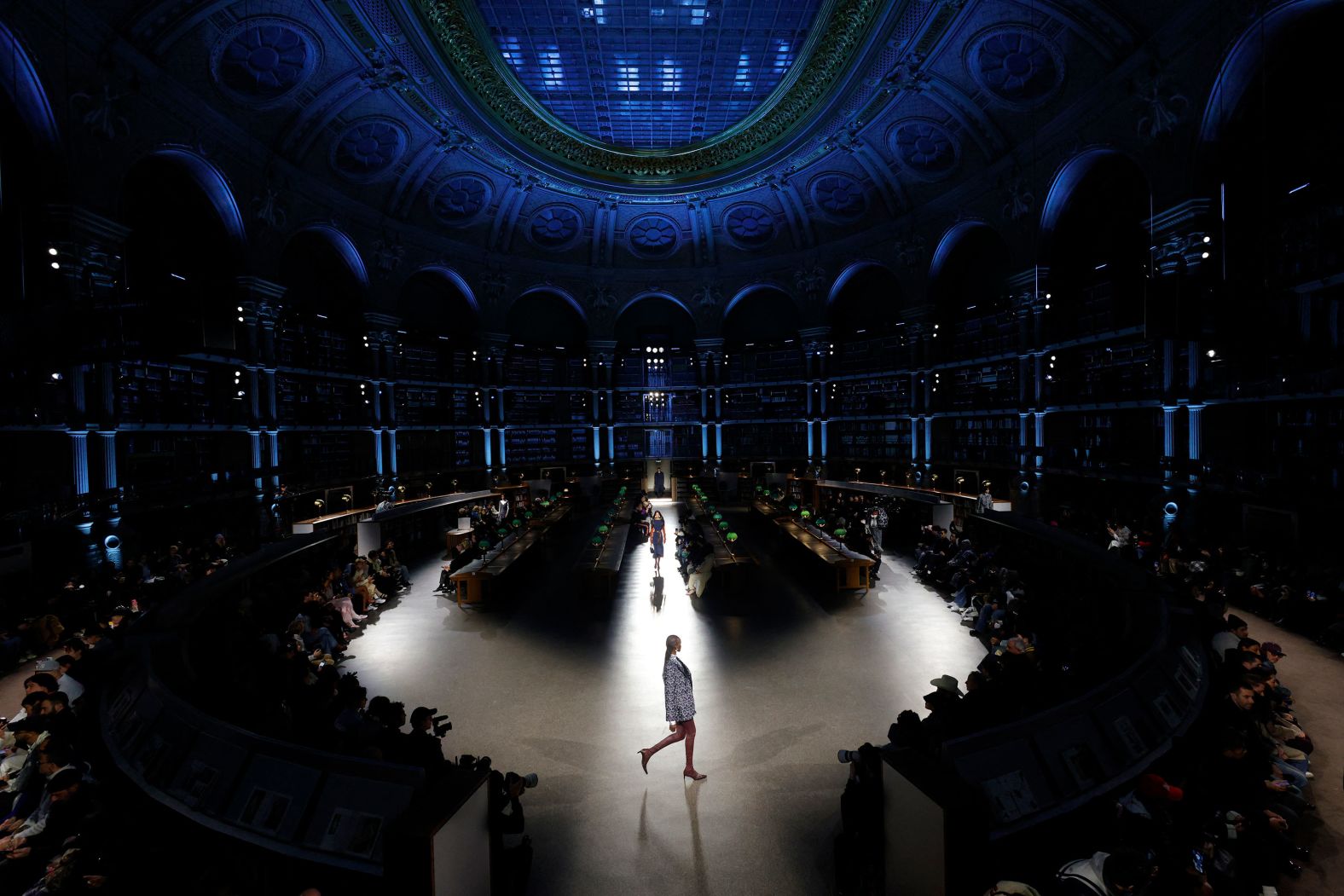 Models take part in a Kenzo fashion show that was being held Friday, January 19, in the Richelieu national library in Paris.