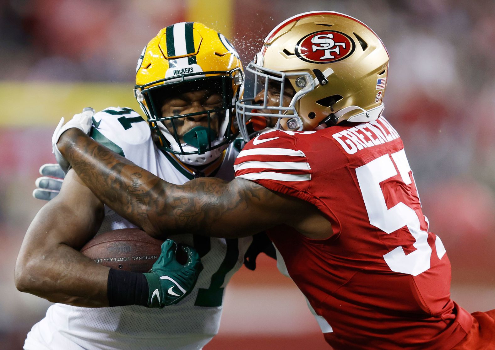 San Francisco 49ers linebacker Dre Greenlaw tackles the Green Bay Packers' Emanuel Wilson during an NFL playoff game on Saturday, January 20. Greenlaw had two interceptions, including the game clincher, as <a href="index.php?page=&url=https%3A%2F%2Fwww.cnn.com%2F2024%2F01%2F21%2Fsport%2Fsan-francisco-49ers-baltimore-ravens-nfl-playoffs%2Findex.html" target="_blank">the 49ers won 24-21</a> and advanced to the NFC Championship game.