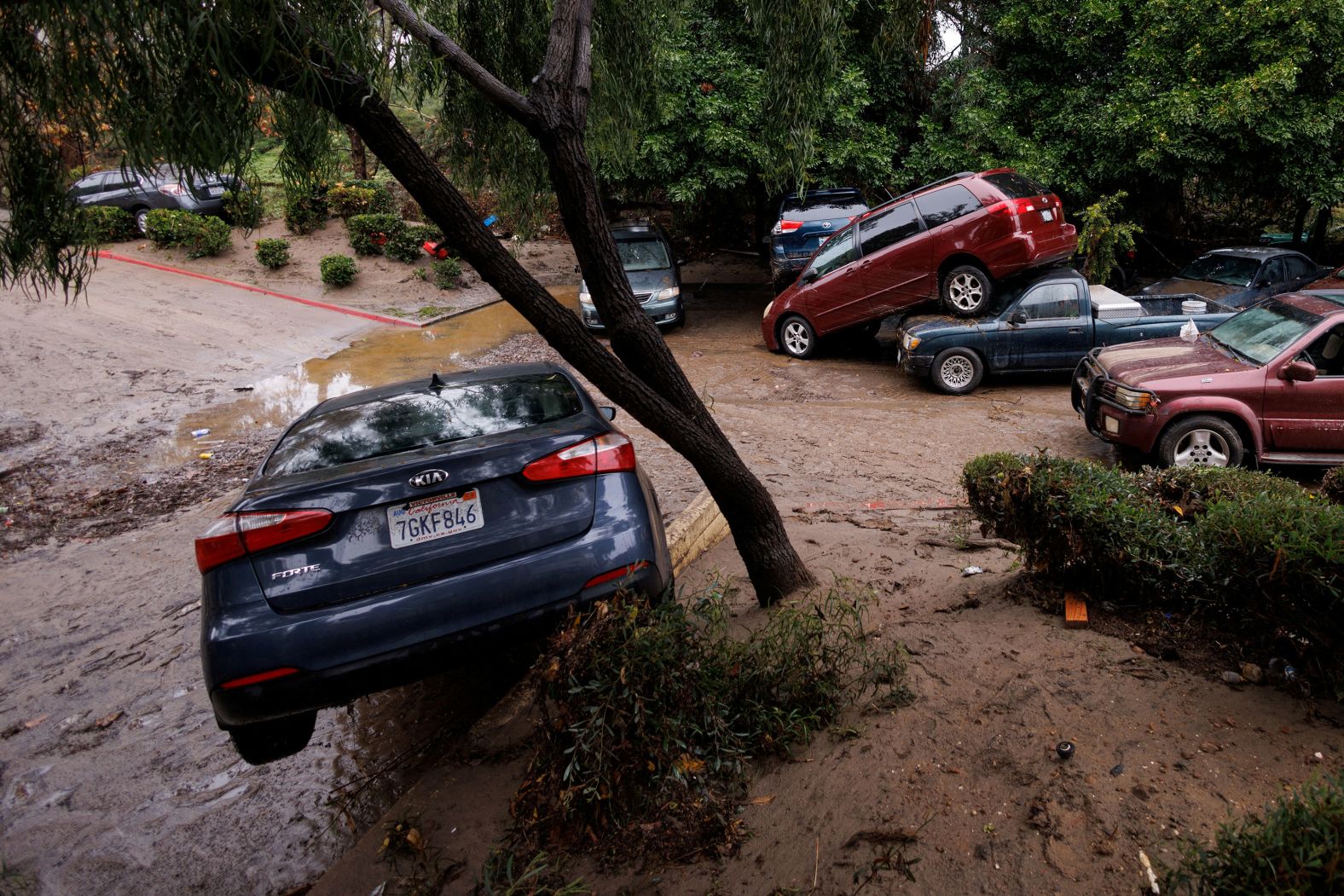 Vehicles are damaged on Monday, January 22, after <a href="index.php?page=&url=https%3A%2F%2Fwww.cnn.com%2F2024%2F01%2F23%2Fweather%2Frain-ice-storm-flooding-forecast-tuesday%2Findex.html" target="_blank">heavy rain</a> sent several feet of fast-moving water rushing through some streets in San Diego.