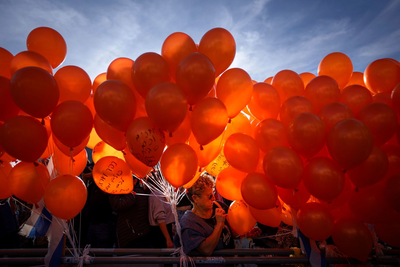 Demonstrators hold orange balloons at a rally in Tel Aviv, Israel, on Thursday, January 18. They were showing solidarity with Kfir Bibas, an Israeli boy who was spending his first birthday in captivity in Gaza. <a href="index.php?page=&url=https%3A%2F%2Fwww.cnn.com%2F2024%2F01%2F18%2Fmiddleeast%2Fkfir-bibas-first-birthday-youngest-hostage-in-gaza-intl%2Findex.html" target="_blank">Kfir is the youngest of the 253 hostages</a> who were taken into Gaza by Hamas and other militant groups during the terror attacks against Israel in October.