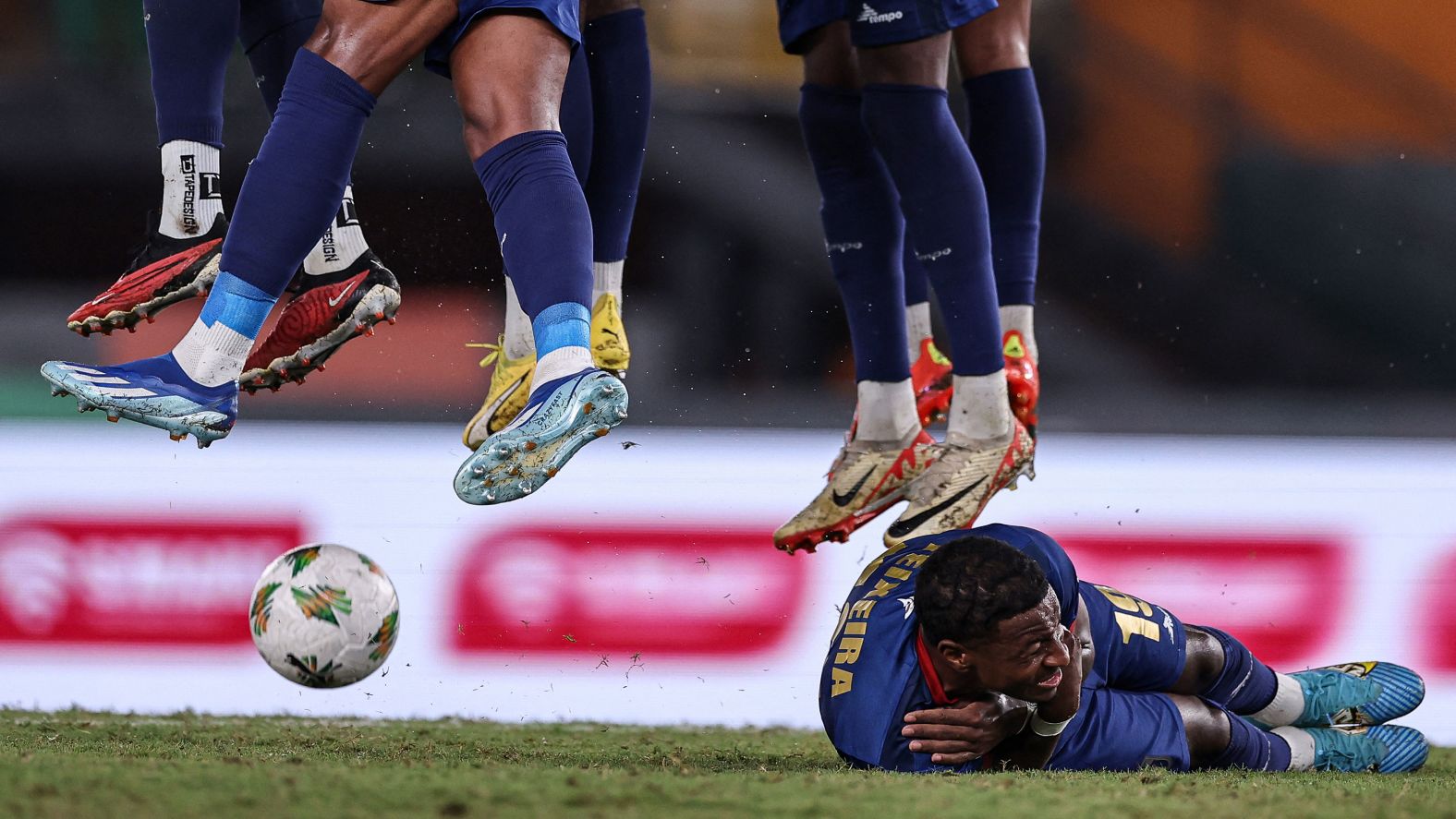 Cape Verde forward Bryan Teixeira lies on the ground, and his teammates jump in the air, as they try to block a free kick during a match against Egypt at the Africa Cup of Nations on Monday, January 22.
