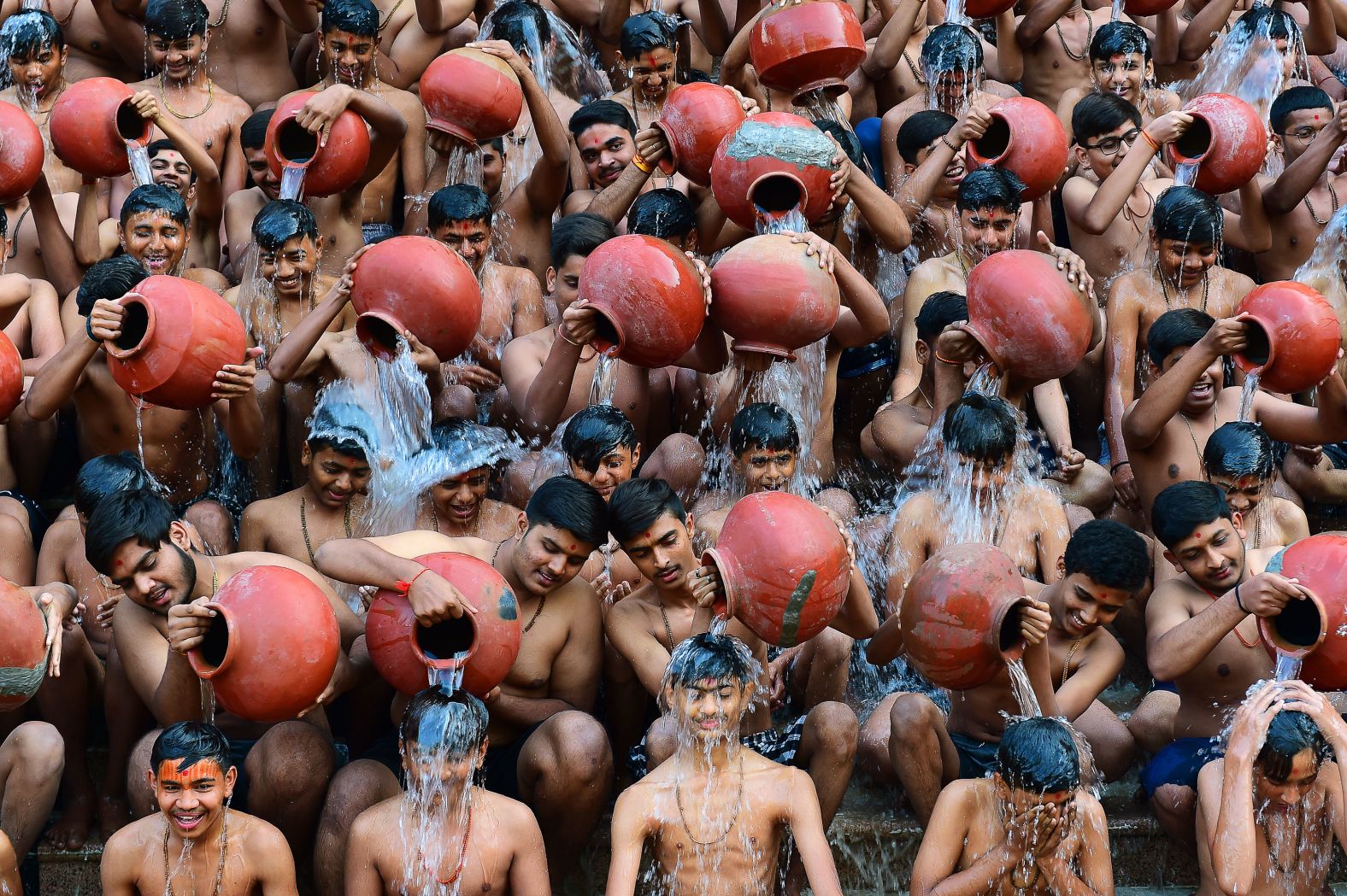 Students from the Swaminarayan Gurukul school take part in a "Magh Snan," or holy bath, in Ahmedabad, India, on Wednesday, January 24.