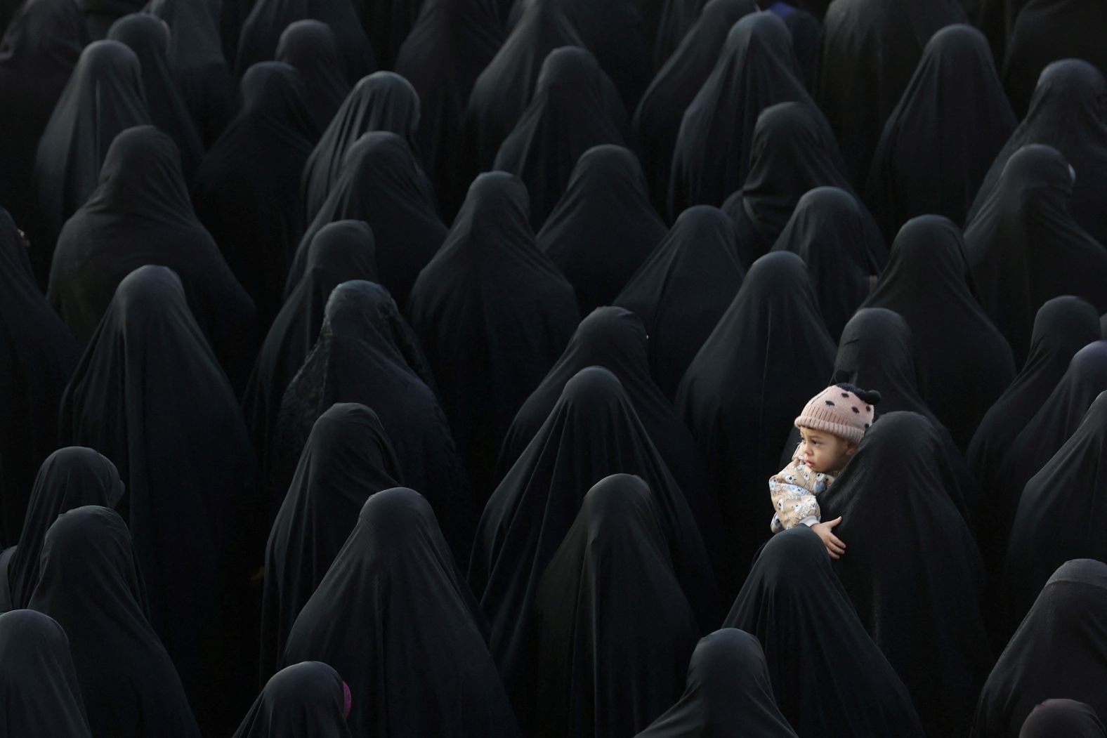 A woman holds a child in Tehran, Iran, as people gather for the funeral of Hojjatollah Omidvar and Mohammad Amin Samadi, members of Iran's Islamic Revolutionary Guards Corps, on Monday, January 22. The two were among <a href="index.php?page=&url=https%3A%2F%2Fwww.cnn.com%2F2024%2F01%2F20%2Fworld%2Firan-israel-missile-damascus-military-intelligence-intl%2Findex.html" target="_blank">five Iranian military advisers killed in an Israeli missile strike</a> on a building in Damascus, Syria, on January 20, Iran's semi-official Tasnim news agency reported. The alleged strike targeted the Mazzeh neighborhood in Syria's capital, home to several diplomatic missions including the Iranian embassy, according to Syrian authorities. The Israel Defense Forces declined to comment on the incident, telling CNN, "We do not comment on foreign reports." <a href="index.php?page=&url=http%3A%2F%2Fwww.cnn.com%2F2024%2F01%2F18%2Fworld%2Fgallery%2Fphotos-this-week-january-11-january-18-ctrp%2Findex.html" target="_blank">See last week in 36 photos</a>.