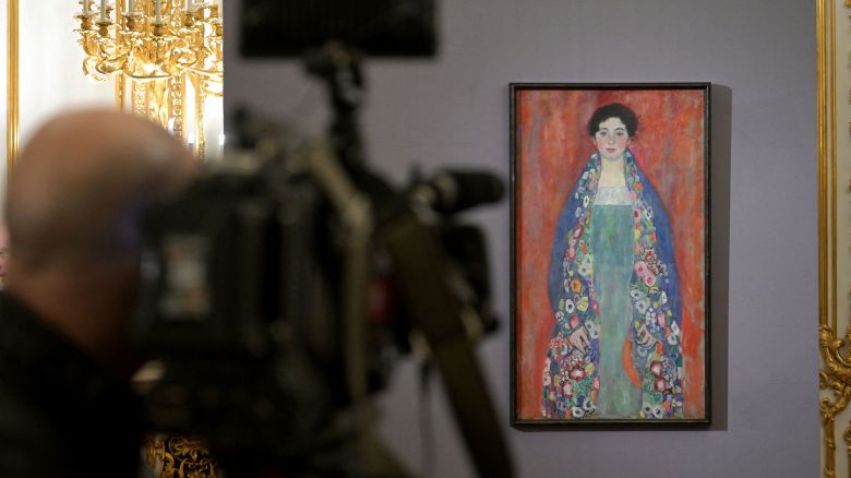 A cameraman takes footage of the painting 'Bildnis Fraeulein Lieser' (Portrait of Miss Lieser) by Austrian artist Gustav Klimt (1862 - 1918) during a press conference of the Kinsky Art Auction House in Vienna, Austria on January 25, 2024. A late painting by Austrian artist Gustav Klimt has resurfaced in a private collection and will be sold in April, Viennese auction house Kinsky said on January 25. 'Bildnis Fraeulein Lieser' (Portrait of Miss Lieser) was commissioned by a wealthy Jewish industrialist's family and painted by Klimt in 1917 shortly before he died. (Photo by ROLAND SCHLAGER / APA / AFP) / Austria OUT / RESTRICTED TO EDITORIAL USE - MANDATORY MENTION OF THE ARTIST UPON PUBLICATION - TO ILLUSTRATE THE EVENT AS SPECIFIED IN THE CAPTION (Photo by ROLAND SCHLAGER/APA/AFP via Getty Images)